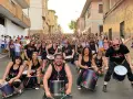 Grupo de percusionistas alegra las fiestas en España en septiembre. Multitud celebra en la calle.