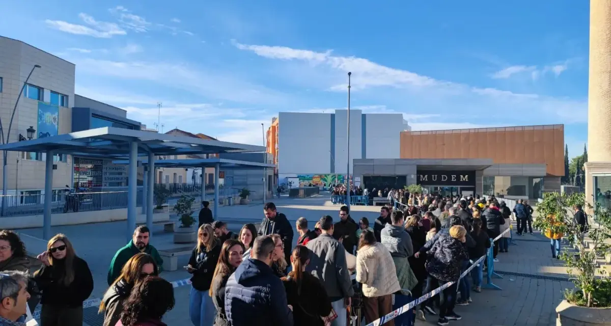 Larga cola de gente esperando para entrar al Mudem, un evento cultural en Murcia.