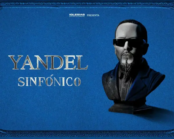 Yandel Sinfónico, un busto del artista con gafas oscuras y barba, sobre un fondo azul texturizado con adornos dorados. Iglesias Entertainment presenta.