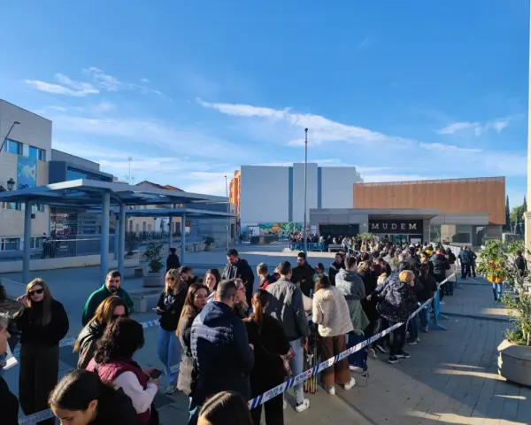 Larga cola de gente esperando para entrar al Mudem, un evento cultural en Murcia.