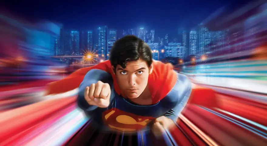 Superman vuela a toda velocidad sobre una ciudad nocturna, evocando la icónica banda sonora de Superman.