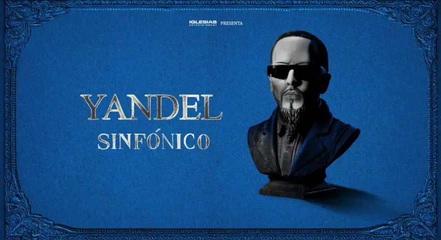 Yandel Sinfónico, un busto del artista con gafas oscuras y barba, sobre un fondo azul texturizado con adornos dorados. Iglesias Entertainment presenta.
