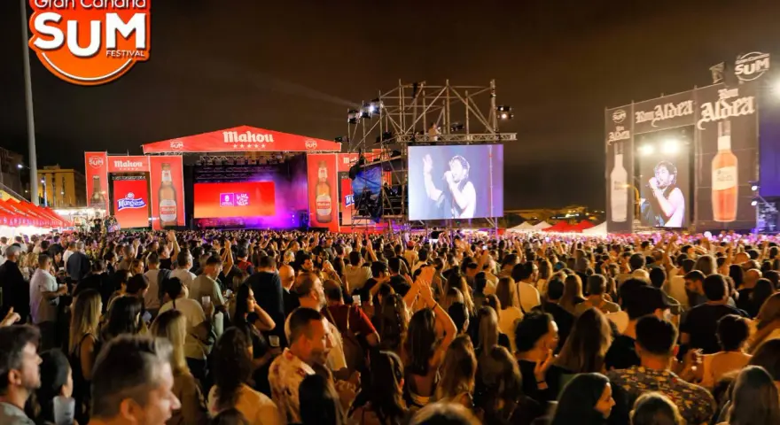 Multitud vibrante en el Gran Canaria SUM Festival, disfrutando de la música en vivo bajo un cielo nocturno.