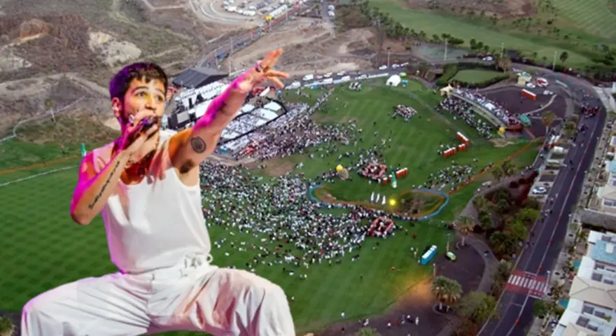 Camilo canta en un multitudinario concierto al aire libre. El artista, con su característico estilo, domina el escenario ante miles de fans.