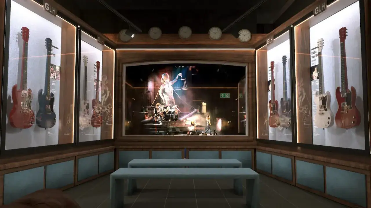 Exhibición de guitarras icónicas en un museo, con una pantalla central mostrando una banda en concierto. Un lugar perfecto para los amantes de la guitar bcn.
