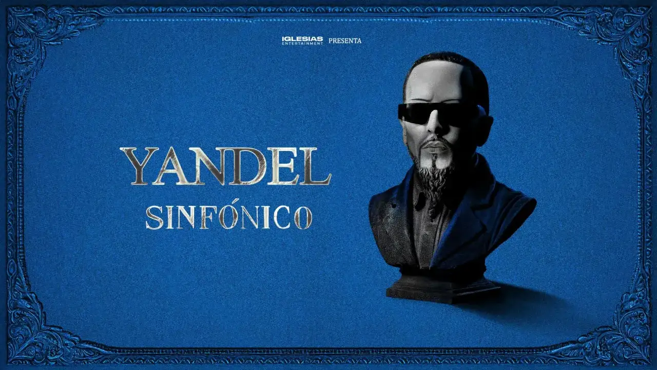 Yandel Sinfónico, un busto del artista con gafas oscuras, sobre un fondo azul texturizado con adornos dorados. Iglesias Entertainment presenta.
